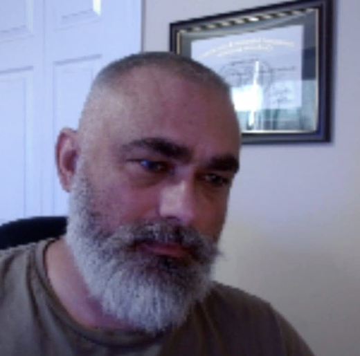 Documentary portrait of Tyler — gray beard, soft vignette